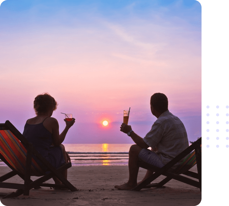 Photo of a couple enjoying sunset at the beach